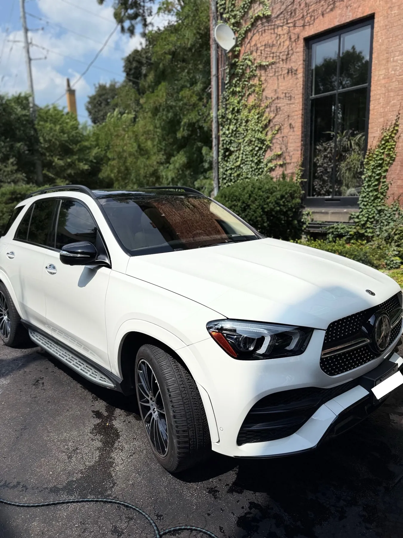 Freshly detailed white Mercedes-Benz SUV parked outdoors